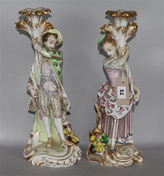 A pair of French porcelain candlesticks